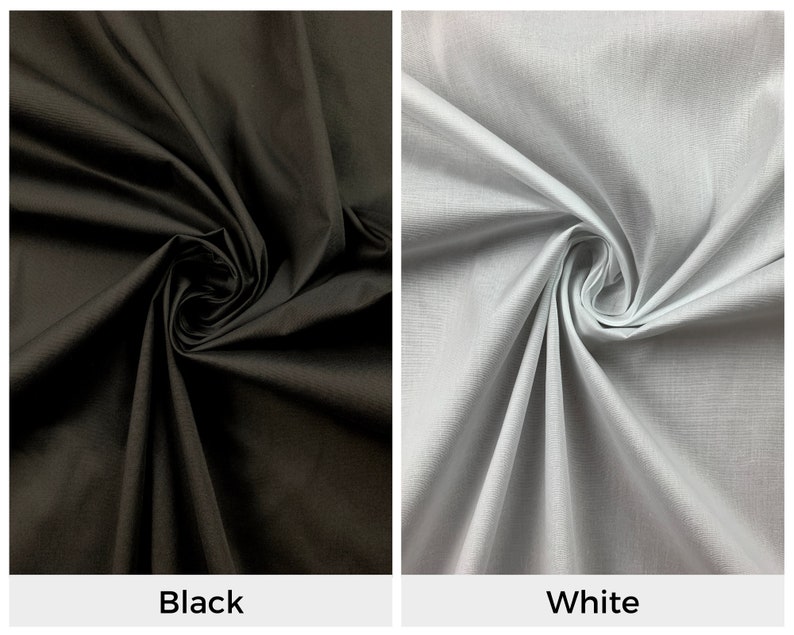 May include: Two fabric swatches, one black and one white, are shown folded and twisted. The fabric is smooth and has a subtle sheen.