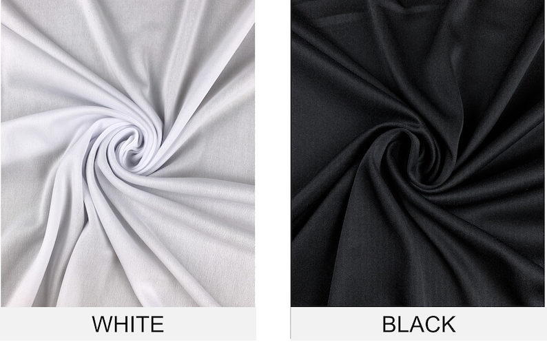 May include: Two fabric swatches, one white and one black, are shown in a close-up view. The fabric is smooth and has a slight sheen. The swatches are arranged in a swirl pattern.