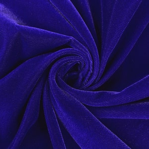 May include: Close-up of a deep blue velvet fabric, showing the soft texture and folds of the material.
