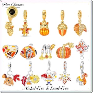 May include: A collection of fifteen gold-tone and silver-tone metal charms featuring autumn themes including pumpkins, scarecrows, squirrels, acorns, and maple leaves. Some charms are accented with orange, yellow, and white enamel or clear crystals.