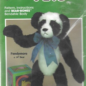 May include: A plush panda bear toy named "Pandymore" with a blue bow, approximately 14 inches tall. The packaging includes the text "POSEABLE PETS" and "BEAR-BONES" with a bendable body design. A colorful block is also visible.