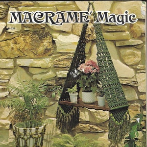 May include: A vintage magazine cover titled "Macrame Magic" features macrame plant hangers and planters. The image showcases a variety of macrame designs in green and brown, with plants in white pots and a wooden shelf against a stone wall.