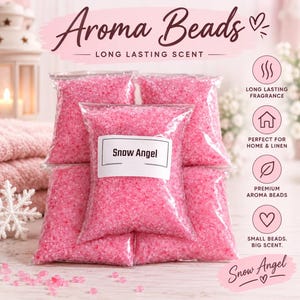 May include: Five clear plastic bags filled with small, bright pink aroma beads. The front-most bag features a white rectangular label with the black text 'Snow Angel'. The text 'Aroma Beads' and 'LONG LASTING SCENT' appear at the top.