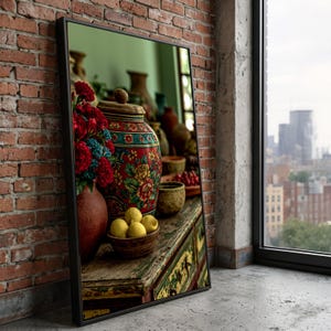 May include: A rectangular framed wall art piece depicting a still life scene with a large red patterned ceramic jar, a terracotta vase filled with red flowers, and a small wooden bowl containing four yellow lemons on a weathered wooden surface.