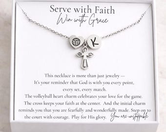 May include: Silver necklace with a volleyball heart charm, a cross pendant, and an initial charm. The necklace is presented in a white box with the text "Serve with Faith, Win with Grace". The necklace is a reminder of faith and love for the game.