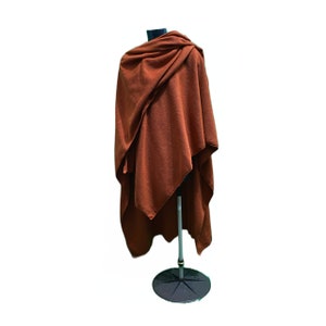 polar fleece wrap with long pointed pixie hood.Can be worn as a cape. Generously sized, measuring approximately 57 inches wide, and a back length of 44 inches. The bottom edges are cut into scallops andfinished with an overlock stitch.