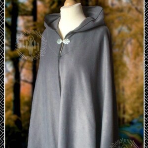 May include: A grey hooded cloak with a silver clasp. The cloak is made of a soft, warm fabric and has a simple, elegant design.