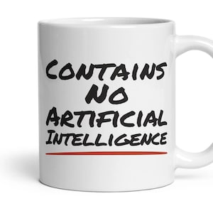 May include: A white ceramic mug featuring the black text "CONTAINS NO ARTIFICIAL INTELLIGENCE" printed in a bold, hand-lettered style font. A thin, horizontal red line is positioned directly underneath the text on the front of the mug.