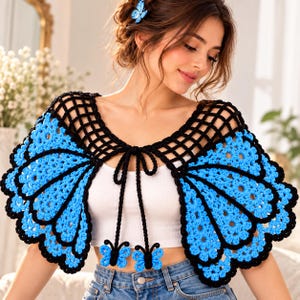 May include: A crochet shawl designed to resemble butterfly wings, featuring vibrant blue yarn with black outlines. The garment has a black lattice-patterned neckline and two long black ties hanging down, each ending in a small blue butterfly motif.