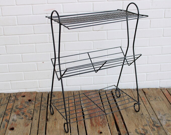 Distressed Vintage Black Metal Floor Shelf With One V Shaped Shelf and