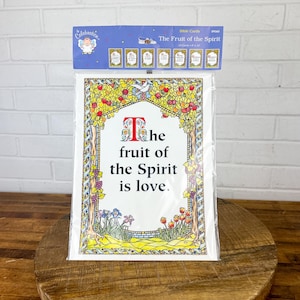 May include: A white card with a colorful floral border and the text "The fruit of the Spirit is love."  The card is part of a set of Bible cards.