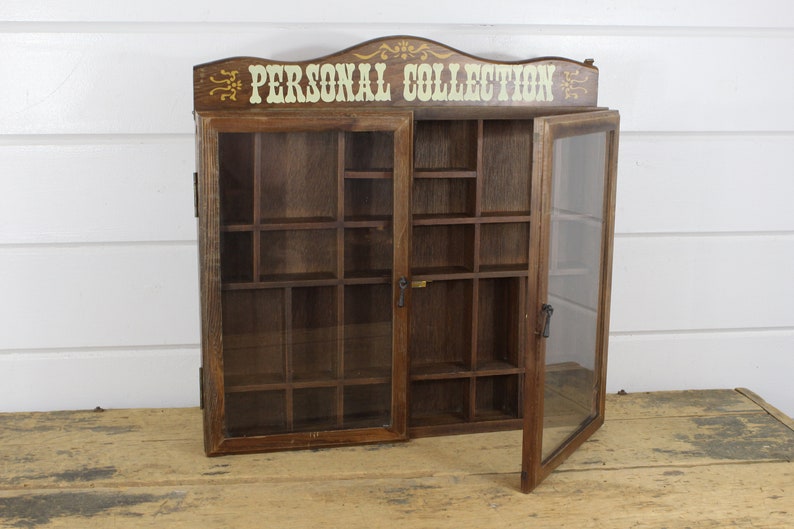 Vintage Personal Collection Curio Cabinet Glass Doors 26 Slots Cubbies 17 By 16 Wall Hanging Trinket Holder Various Size Holes Old