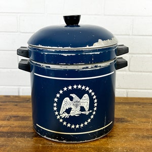 May include: Blue and white metal double steamer with a black knob and a white eagle design with stars.
