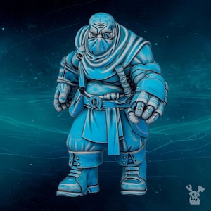 May include: A miniature figurine of a stout, muscular character rendered in shades of bright blue and white. The figure wears a face mask, a hooded garment, a belt with a buckle, and heavy boots. A small skull emblem is visible on the shoulder.