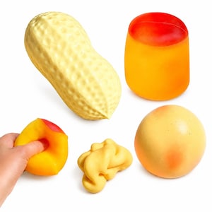 May include: A collection of five squishy sensory toys including a textured light yellow peanut, a cylindrical orange and red object, a round yellow and orange sphere, a small yellow malleable shape, and a yellow and red object being squeezed.