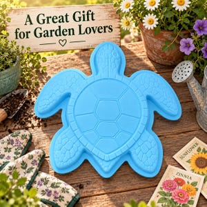 May include: A bright blue silicone baking mould shaped like a sea turtle with a detailed shell pattern and flippers. The mould features a smooth, raised surface design and is positioned centrally, showcasing the distinct outline of the turtle creature.