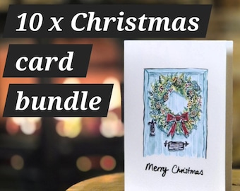 May include: A bundle of 10 Christmas cards featuring a white card with a watercolour illustration of a light blue door adorned with a festive wreath and a red bow. The text "Merry Christmas" is printed in black ink at the bottom of the card.