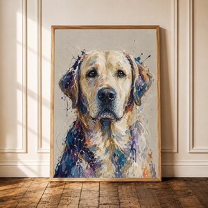 May include: A framed wall art print featuring a portrait of a golden Labrador retriever. The dog is rendered in an expressive style with visible brushstrokes and paint splatters in shades of blue, purple, and orange against a neutral background.
