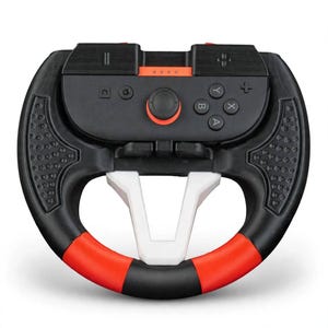 May include: A black and red racing wheel controller accessory featuring a central black game controller with A, B, X, and Y buttons, a joystick, and menu buttons. The steering wheel frame has a white center support and textured black side grips.