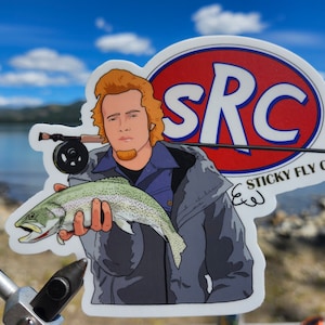 May include: A sticker featuring a cartoon illustration of a person holding a trout fish. The sticker has a red, white, and blue logo that says "SRC" and "STICKY FLY CO."