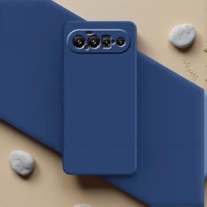 May include: A solid navy blue smartphone case featuring a rectangular camera cutout at the top. The case has a smooth, matte finish and is designed to fit a device with a horizontal camera array, showing four distinct circular lens openings.