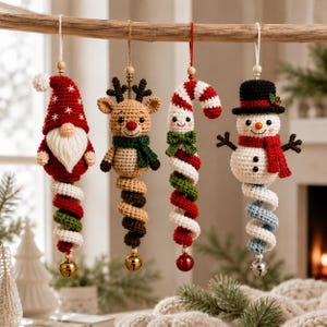 May include: Four crocheted Christmas ornaments hanging from a branch. The set includes a gnome in a red hat, a tan reindeer with a green scarf, a red and white candy cane with a green bow, and a snowman in a black hat with a red scarf.