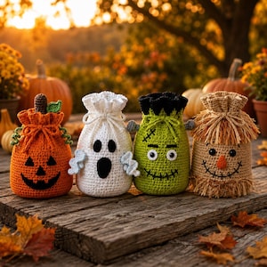 May include: Four crochet drawstring bags featuring Halloween characters: an orange pumpkin with a brown stem, a white ghost with black eyes and mouth, a green monster with black hair and stitches, and a tan scarecrow with a fringed top.