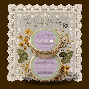 May include: Two round gold-coloured metal tins of The Sick Healer Rapha Balm, net weight 57 g. The top lid features a green and purple label with floral illustrations. The bottom tin shows a detailed ingredient list and usage instructions in text.