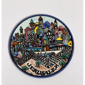 May include: A round ceramic tile featuring a colorful, hand-painted illustration of the Jerusalem cityscape. The design includes various architectural structures, domes, and towers in shades of blue, yellow, and brown, with the word JERUSALEM printed.