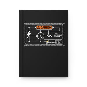 May include: A black hardcover journal featuring a white and orange graphic of an electrical circuit diagram. The design includes a caution sign, a lightning bolt, and the text "LOAD: CONTINUOUS SARCASM" alongside a "BearTaDa" manufacturer label.