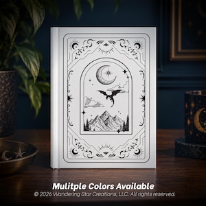 May include: A white hardcover book featuring a black line art illustration on the front cover. The design depicts a dragon flying over mountain peaks beneath a crescent moon and stars, all framed within an ornate, rectangular border pattern.