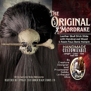May include: A handmade, customizable hair accessory featuring a skull and bone design. The hair stick slide is made of leather, handcarved wood, and resin. The text reads "The Original Mordrake" and "Handmade Customizable".