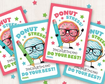 May include: Four printable cards featuring a donut character wearing glasses and holding a pencil. The donut is pink with sprinkles and the text reads "Donut Stress! Take your time and do your best!" The cards are pink and blue.