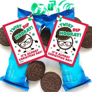 May include: Printable gift tags featuring a cartoon cookie with glasses and the text "Twist Dip Hooray! It's almost Christmas Day!" The tags are red with green and white accents.
