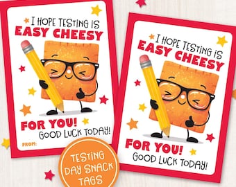 May include: Two printable gift tags with a cartoon cracker wearing glasses and holding a pencil. The tags are red with white and yellow stars. The text on the tags reads "I hope testing is easy cheesy" and "For you! Good luck today!"
