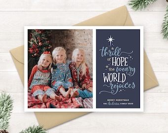 May include: A Christmas card with a photo of three children in front of a Christmas tree. The text on the card reads "A thrill of HOPE the weary WORLD rejoices. Merry Christmas The Anderson Family 2020."