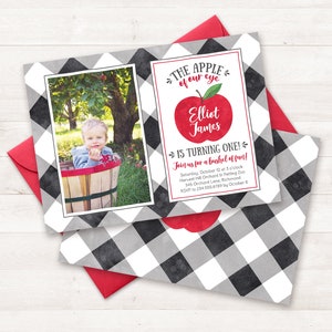 May include: A black and white checked invitation with a red apple graphic. The text reads "The apple of our eye Elliot James is turning one! Join us for a bushel of fun! Saturday, October 12 at 3 o'clock Harvest Hill Orchard by Petting Zoo 345 Orchard Lane, Richmond RSVP to 234.555.6789 by October 8"