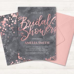 May include: A gray and rose gold bridal shower invitation with a watercolor background and the text "Join us for a Bridal Shower Honoring Amelia Smith" and details about the event.