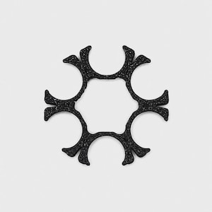 May include: A black, circular, six-pointed star-shaped object with a textured, uneven surface. The design features a central hexagonal opening surrounded by six symmetrical, outward-reaching arms that terminate in flared, bifurcated tips.