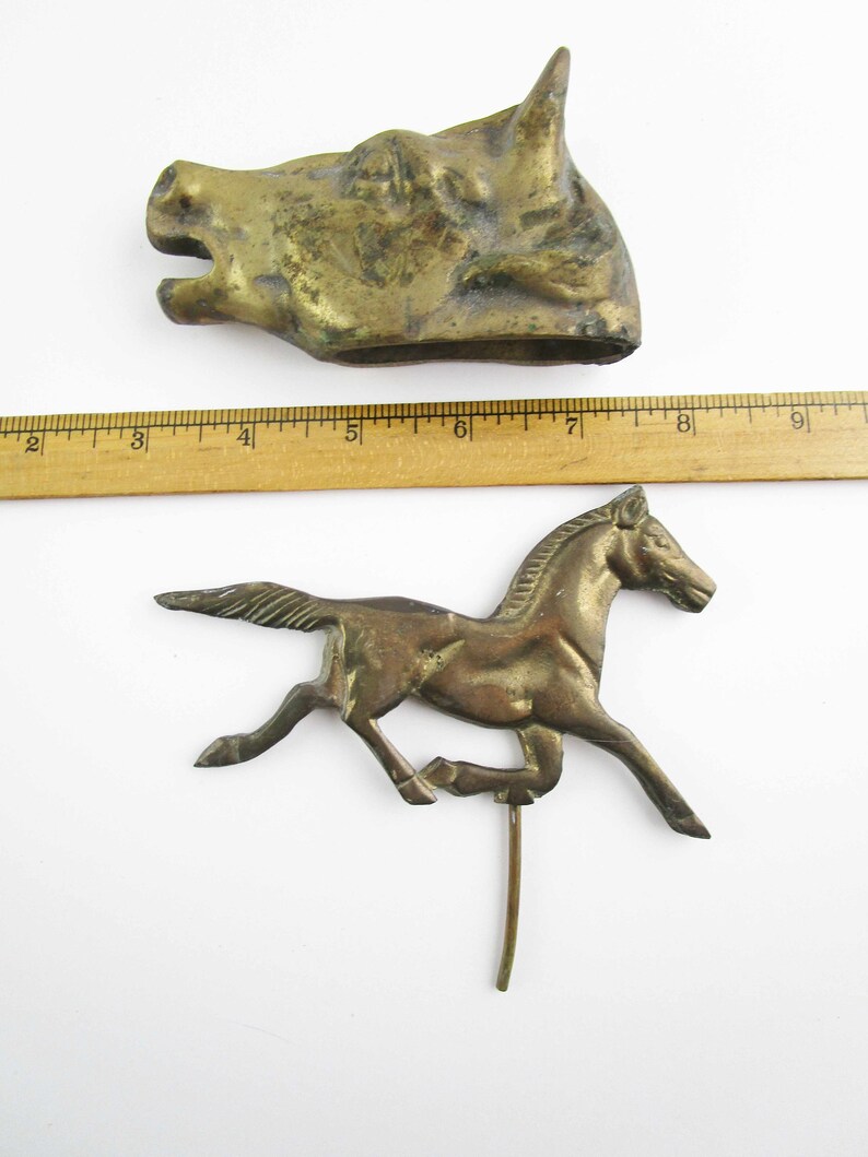 May include: Two antique brass figurines: a horse running and a horse head. The horse head is about 6 inches long and the horse is about 6 inches tall.