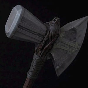 May include: A battle axe featuring a large, metallic, rectangular hammer head on one side and a sharp, triangular axe blade on the other. The handle is crafted from dark, textured wood with a wrapped grip section near the head of the weapon.