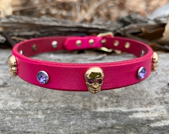 Collare per cani in pelle rosa con teschi dorati, strass viola e finiture dorate