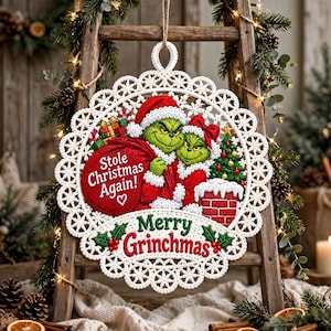May include: A round white crocheted ornament featuring a green character in a red Santa suit holding a red sack with the text Stole Christmas Again! and a smaller green character, a Christmas tree, and the text Merry Grinchmas in red and green.