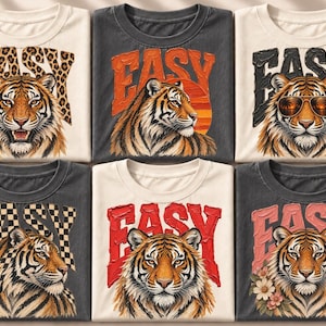 Puede incluir: Seis camisetas con gráficos de tigres y la palabra EASY. Los diseños incluyen estampado de leopardo, un atardecer, gafas de sol, un patrón de cuadros, texto rojo sólido y flores. Las camisetas están dispuestas en una cuadrícula crema y gris.