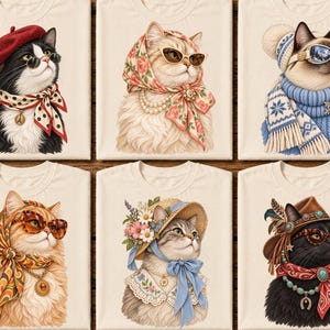 May include: Six cream-colored t-shirts, each featuring a cat illustration. The cats wear various accessories including berets, floral headscarves, winter hats, straw hats, cowboy hats, sunglasses, scarves, and necklaces in diverse colors and patterns.