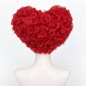 May include: A vibrant red wig styled into a heart shape, featuring dense, tight curls that form a voluminous, rounded silhouette. The hair is a consistent, bright crimson shade throughout, displayed on a plain white mannequin bust.