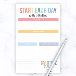 May include: A printable daily planner with a rainbow color scheme. The planner includes sections for today's focus, affirmations, tasks, and things you are thankful for. The text "Start each day with intention" is at the top of the page. The bottom of the page includes the quote "Gratitude is the sign of a noble soul." - AE.