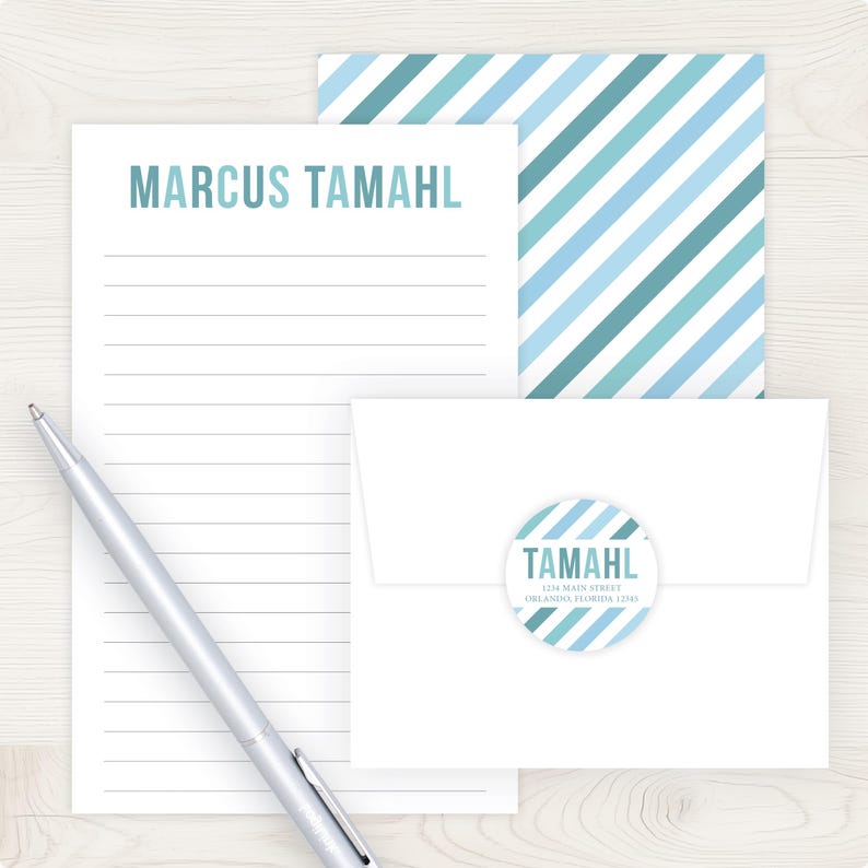 a pen, a piece of paper with a name written on it, and an envelope with a circular label.