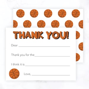 May include: Basketball-themed thank you note cards.  The cards are white with an orange basketball pattern on the top and a single basketball at the bottom. The text on the card says 