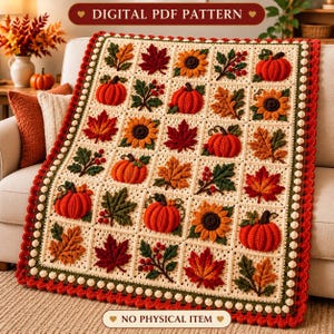 May include: A crochet blanket featuring a grid of square motifs with autumn-themed designs including orange pumpkins, sunflowers, red and brown maple leaves, and berry sprigs. The blanket has a cream background and a red scalloped border.